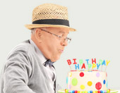 older man with birthday cake